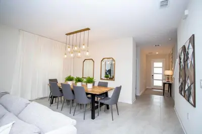 a dining room and living room with a table and chairs at Stunning 5BR Home - Your Dream Getaway in Kissimmee