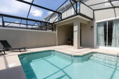 a swimming pool in the middle of a house at Chic Retreat - Unforgettable Stay in Kissimmee