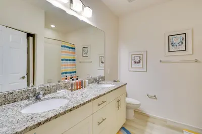a bathroom with two sinks and a large mirror at New Home Close To Disney Bliss! in Kissimmee