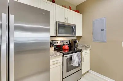 a kitchen with a stainless steel refrigerator and a microwave at New Home Close To Disney Bliss! in Kissimmee