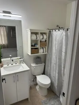 a bathroom with a toilet and a sink and a mirror at Magical Serenity in Orlando