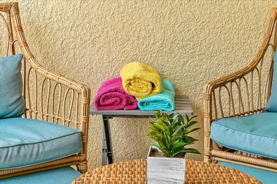 two towels sitting on a table next to two chairs at Magical Serenity in Orlando