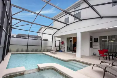 a house with a swimming pool with a glass ceiling at Home 6BR - Prime Location in Kissimmee