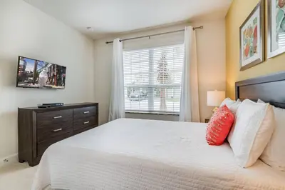 a bedroom with a large bed and a window at Ultimate Getaway - Your Best Vacation Home in Orlando