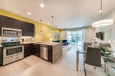 a kitchen and dining room with a table and a dining room at Ultimate Getaway - Your Best Vacation Home in Orlando