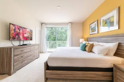 a bedroom with a large bed and a large window at Ultimate Getaway - Your Best Vacation Home in Orlando