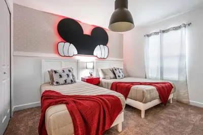 a bedroom with two beds with red blankets at Stunning Themed Home Private Pool Ideal Location in Kissimmee