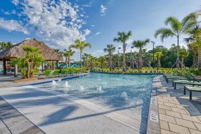 a pool at the resort with swans in the water at Stunning Themed Home Private Pool Ideal Location in Kissimmee
