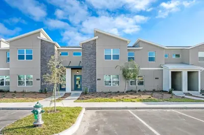 a large apartment building with a fire hydrant at Stunning Themed Home Private Pool Ideal Location in Kissimmee