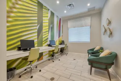 an office with chairs and a desk with a computer at Stunning Themed Home Private Pool Ideal Location in Kissimmee