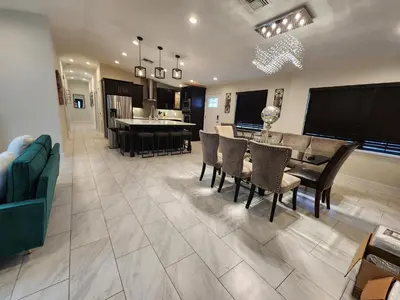 a kitchen and dining room with a table and chairs at The Villa Orlando College Park Sleeps16 - Monthly Stays in Orlando