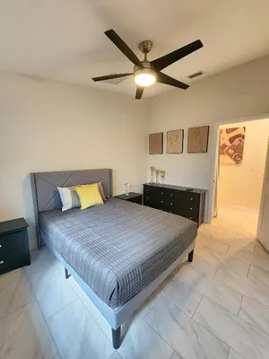 a bedroom with a bed and a ceiling fan at The Villa Orlando College Park Sleeps16 - Monthly Stays in Orlando