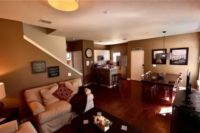 a living room with a couch and a dining room at ABC Vacation Homes in Kissimmee