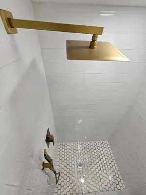 a bathroom with a sink and a toilet with a light at The Hideaway DT Orlando Tiny Home w Free Parking in Orlando