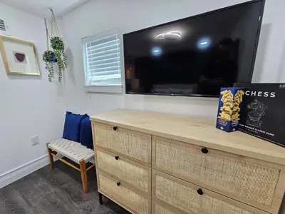 a dresser with a flat screen tv on top of it at The Hideaway DT Orlando Tiny Home w Free Parking in Orlando