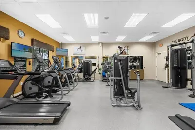 a gym with several treadmills and cardio machines at Cozy Orlando Resort Condo 4Mi from Disney in Orlando