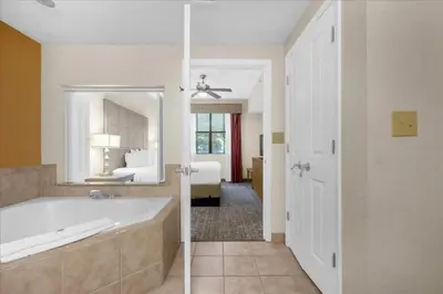 a bathroom with a tub and a bedroom with a bed at Cozy Orlando Resort Condo 4Mi from Disney in Orlando