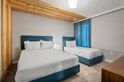 a bedroom with two beds and a window at New Home 8 Bedrooms and 5 Bathrooms At Storey Lake in Kissimmee