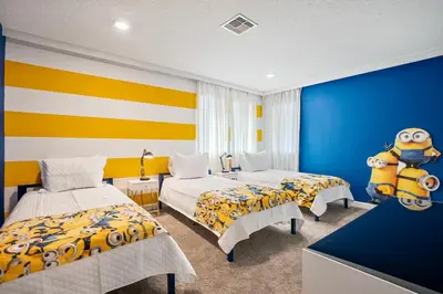 a bedroom with two beds and a large minion toy at New Home 8 Bedrooms and 5 Bathrooms At Storey Lake in Kissimmee