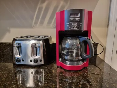a toaster and a coffee maker on a counter at Comfortable Apartment, Close to Disney World in Kissimmee