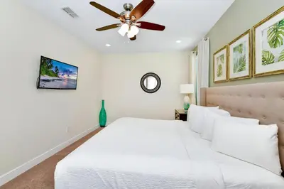 a bedroom with a white bed and a ceiling fan at Lively Home Near Disney With Private Pool, Game And Themed Rooms With Waterpark & Resort Access At Encore Resorts Reunion - 670La in Kissimmee