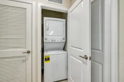 a white washer and dryer in a room at Modern Luxe Condo - Stunning Design in Kissimmee