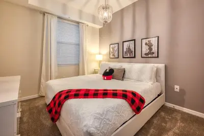 a bedroom with a bed with a stuffed animal on it at Urban Elegance - Modern Retreat in Kissimmee