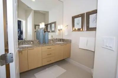 a bathroom with two sinks and a large mirror at Charming Cozy Haven in Orlando