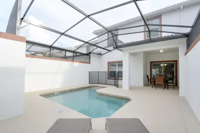 a swimming pool in a house with a glass ceiling at Spacious Cozy Comfort in Every Corner in Kissimmee