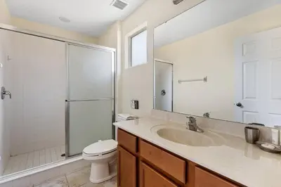 a bathroom with a sink and a shower and a toilet at Enjoy the Large Pool - 6BR BL220 in Kissimmee