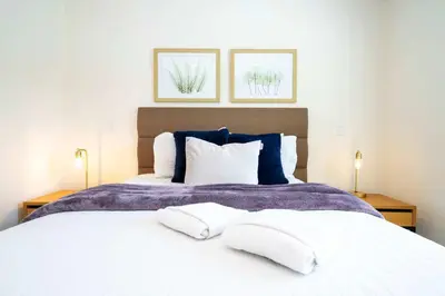 a bedroom with a large bed with two pillows at Spectacular House with 3BR - Private Pool, BBQ - Minutes from Disney! in Kissimmee