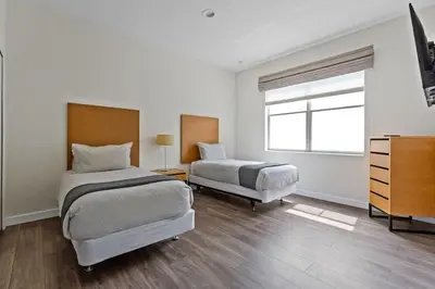 a bedroom with two beds and a dresser and a window at 4 BR Hot Tub Cozy Decor @ Regal Oaks RO2761N in Kissimmee
