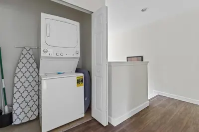 a laundry room with a washer and dryer next to a door at 4 BR Hot Tub Cozy Decor @ Regal Oaks RO2761N in Kissimmee