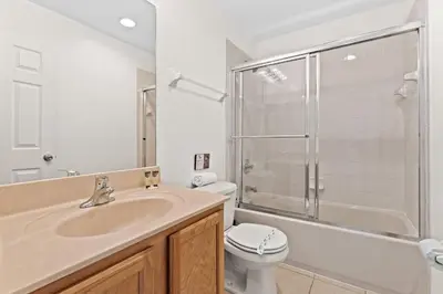 a bathroom with a sink and a toilet and a shower at 4 BR Hot Tub Cozy Decor @ Regal Oaks RO2761N in Kissimmee