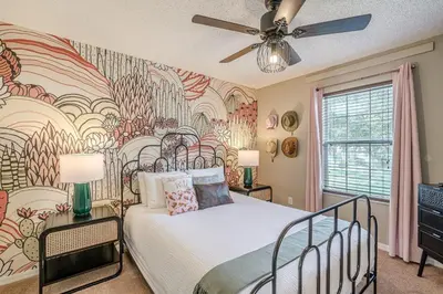 a bedroom with a bed and a large mural at 8575 - 7th Heaven Villa in Kissimmee