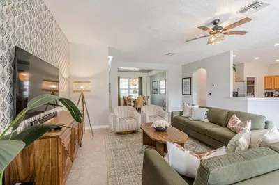 a living room with a couch and a table at 8575 - 7th Heaven Villa in Kissimmee