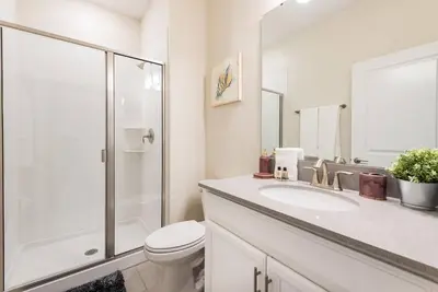 a bathroom with a toilet and a sink and a shower at Themed 4BR Home-Mickey & Star Wars Pool Spacious in Kissimmee
