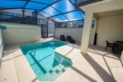 a swimming pool in the middle of a building at Themed 4BR Home-Mickey & Star Wars Pool Spacious in Kissimmee