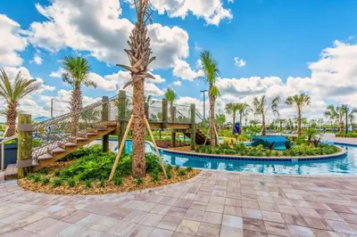 a pool at the resort with a slide and palm trees at Themed 4BR Home-Mickey & Star Wars Pool Spacious in Kissimmee