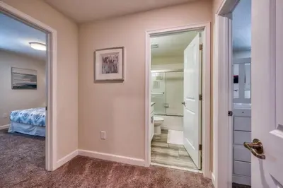 a bathroom with a toilet and a sink and a mirror at Stunning Home Private Pool Great Location in Kissimmee