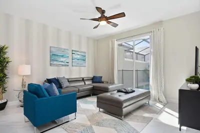 a living room with a couch and a ceiling fan at Storey Lake Townhome 3076 in Kissimmee