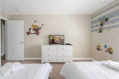 a bedroom with two beds and a white dresser at Storey Lake Townhome 3076 in Kissimmee