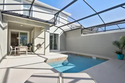 a swimming pool in the middle of a house at Storey Lake Townhome 3076 in Kissimmee