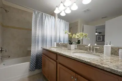 a bathroom with a sink and a tub and a shower at Charming 4 BDR townhome at Storey Lake Resort in Kissimmee