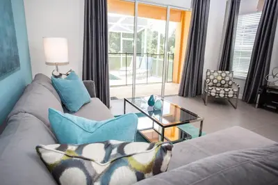 a living room with a couch and a glass table at Serene Villa with Private Pool in Orlando