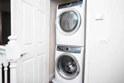 a washer and dryer in a room next to a door at Serene Villa with Private Pool in Orlando