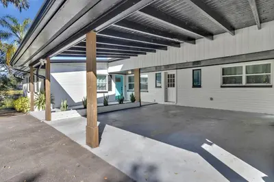 a large garage with a roof over a parking lot at Modern Lake Front Casita near Winter Park! in Orlando