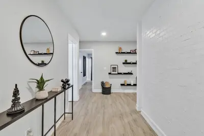 a hallway with a mirror and a white wall at Modern Lake Front Casita near Winter Park! in Orlando