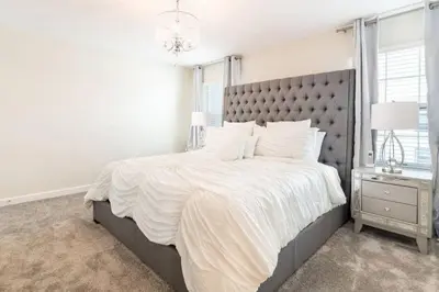 a bedroom with a large bed with a gray headboard at Best Vacation Villa, Themed Beds, Private Pool in Kissimmee