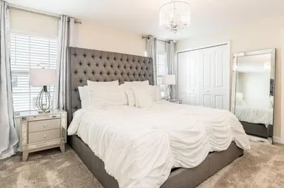 a bedroom with a large white bed and a large mirror at Best Vacation Villa, Themed Beds, Private Pool in Kissimmee